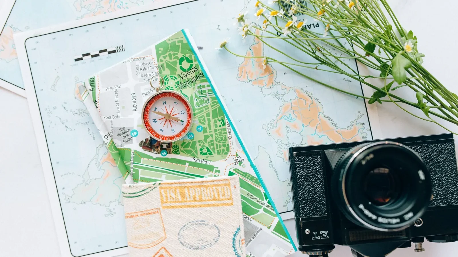 Explore your wanderlust with maps, a compass, and a vintage camera.