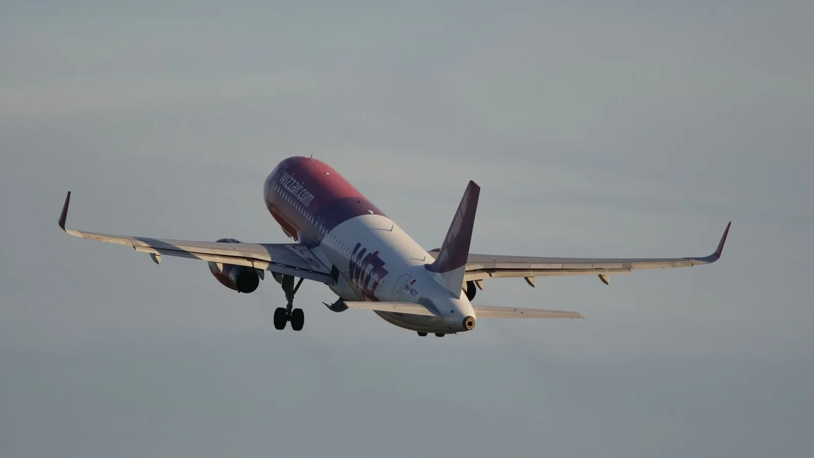 A passenger airplane ascends into the sky, symbolizing travel and adventure.