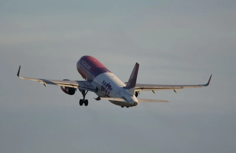 A passenger airplane ascends into the sky, symbolizing travel and adventure.
