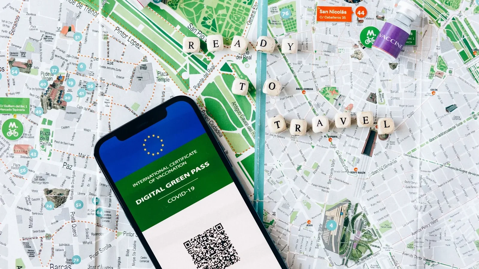 Digital Green Pass on phone with map background and travel concept.