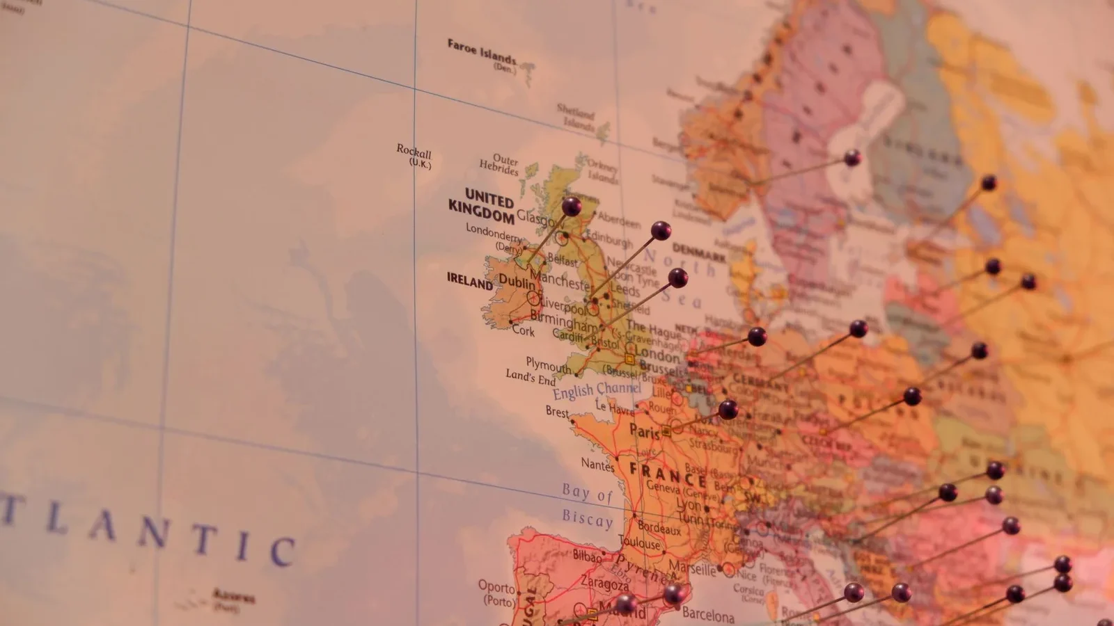 Close-up of a map with push pins marking countries in Europe, including Ireland and the UK.