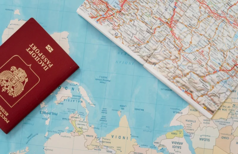 Flat lay of a passport and map, symbolizing travel adventure and exploration.
