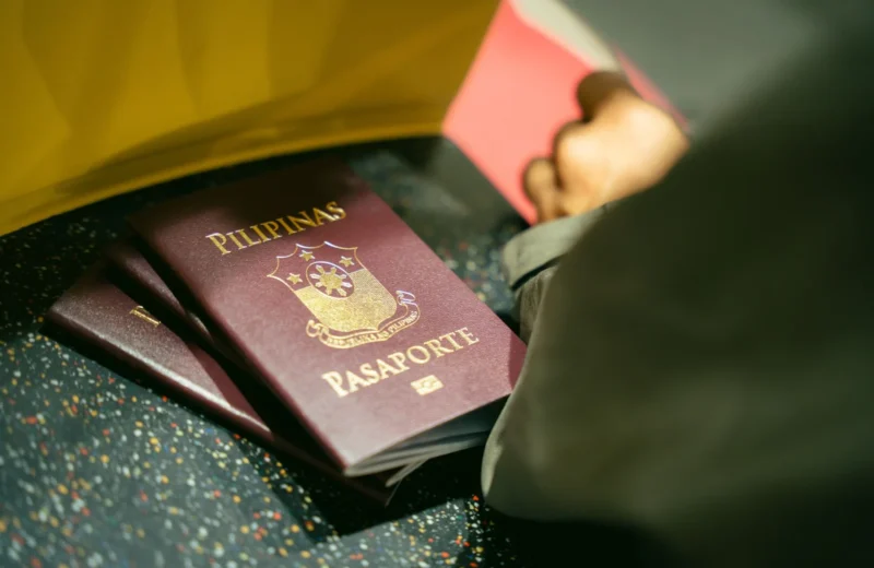 A close-up shot of Filipino passports at the airport, indicating travel and identity.