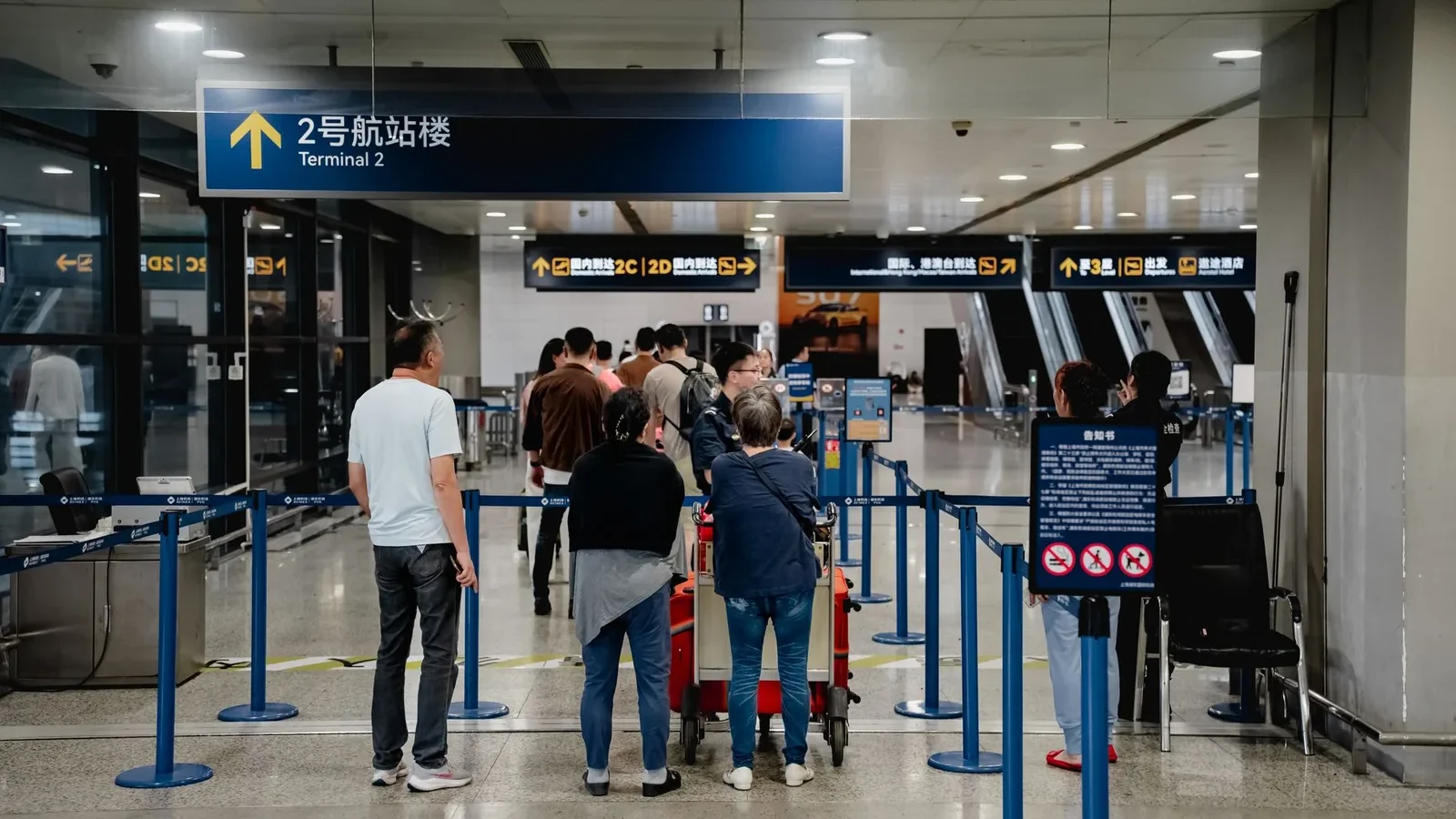 Passengers queue at Terminal 2 in Shanghai Airport, China.