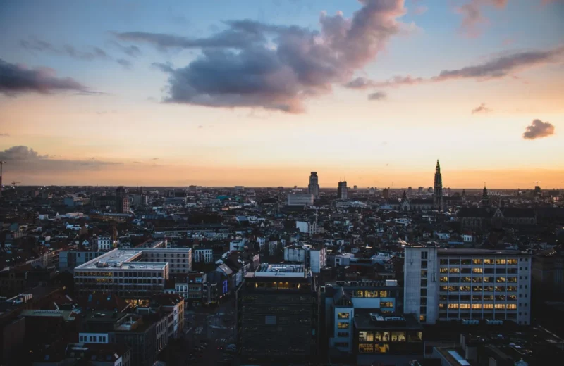 A stunning aerial view of Antwerp, Belgium, cityscape at dusk with vibrant sky colors.