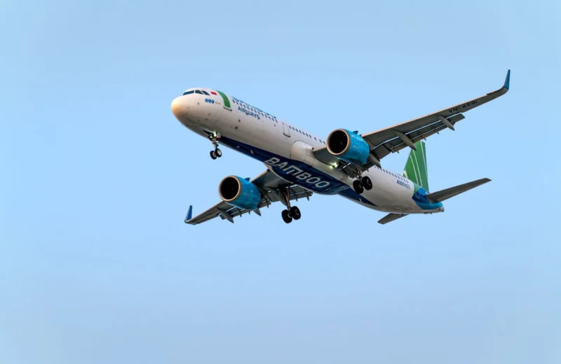 Low angle view of Bamboo Airways Airbus A321 flying against a blue sky.