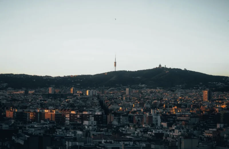 Stunning view of Barcelona with Collserola Tower silhouetted against the evening sky.